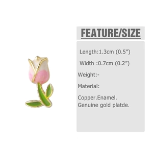 Detail view of tulip earrings with pink enamel gradient and green leaves on gold plating