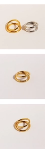 Detail of stacked double-layered crisscross rings in gold and silver finish