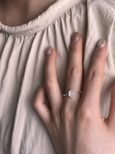 Close-up of minimalist 925 sterling silver ring with oval translucent gemstone and beaded band