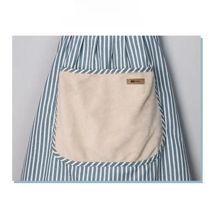 Detail of blue striped apron featuring a soft beige coral fleece pocket for hand drying