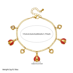Golden stainless steel bracelet with red ladybug enamel charm and crystal heart pendant