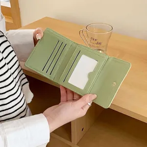 Three-fold minimalist light green wallet featuring multiple card slots and an ID window