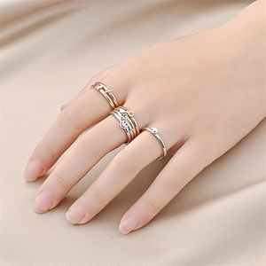 Titanium steel butterfly and smiley face ring set displayed on champagne silk fabric