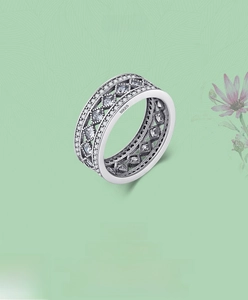 Macro shot of S925 sterling silver wide band ring featuring micro-pave diamonds and cutout
