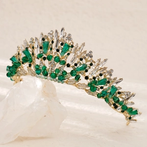 Luxury bridal jewelry set with gold tiara featuring emerald green crystals and diamonds