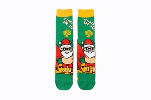 Detail of green cotton crew socks featuring summer Santa Claus and pineapple patterns