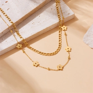 Double-layered gold plated stainless steel necklace with Figaro chain and flower charms