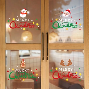 Macro view of Santa and snowman Christmas window stickers on a glass pane in a cozy cafe