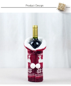 Detail of red knitted wine bottle cover with white elk and snowflake festive patterns