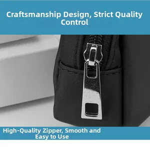 Detailed close-up of smooth metal zipper and textured fabric on black outdoor waist bag