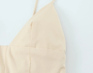 Detailed macro shot of fine poplin fabric texture and neckline stitching of the midi dress