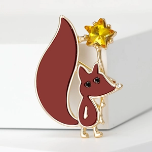 Cute red fox brooch with yellow star jewel on white display stand, gold-plated finish