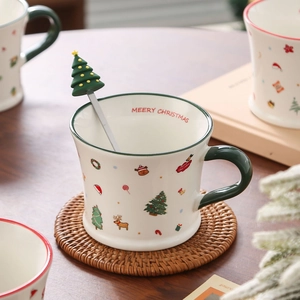 Christmas ceramic mug with Santa patterns and green handle including a tree spoon