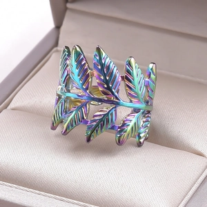 Macro view of rainbow electroplated leaf pattern on stainless steel open ring in a box