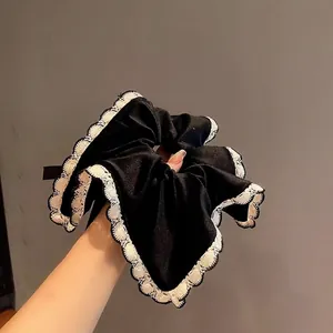 French velvet lace scrunchie in black and white satin for elegant hair styling