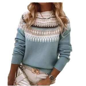 Detailed view of light blue knitted sweater featuring classic Nordic geometric jacquard patterns