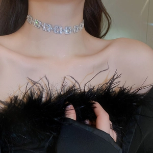 Close-up of a silver-tone heavy square rhinestone choker necklace worn by a female model