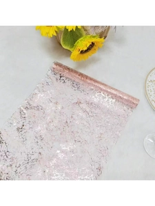 Detail of rose gold mesh table runner with metallic cracked pattern and sunflowers