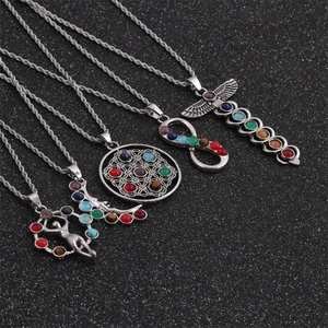 Silver chakra pendant necklace set with rainbow gems and mystical lotus symbols