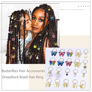 Detail of colorful butterfly and star hair charms for dreadlocks and braided hairstyles