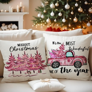 Close-up of pink Christmas truck and tree patterns on linen holiday pillow covers