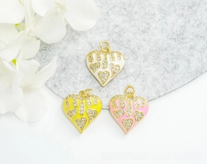 Macro view of 18K gold plated heart charms with enamel drip and micro-inlaid zircons