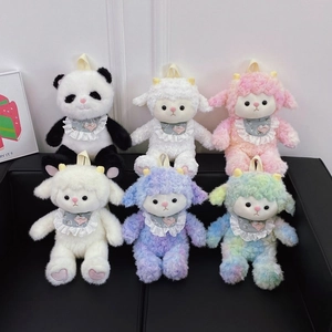 Cute plush sheep and panda dolls with lace bibs arranged on a modern black sofa