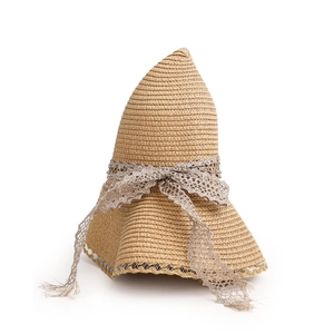 Close-up of woven straw texture and delicate lace bow on the summer sun hat