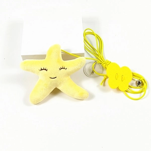 Detail of a yellow plush starfish cat toy with a small bell and transparent hanging ring
