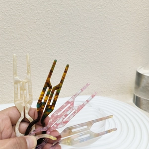 Celluloid acetate U-shaped hair pins in marble and tortoiseshell patterns for bun styling