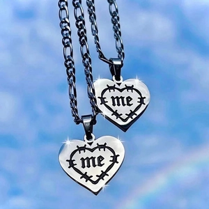 Hip-hop silver heart flame necklaces with me engraving against a blue sky background