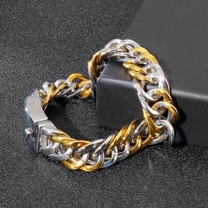 Detail of two-tone gold and silver Cuban link bracelet with box clasp on black jewelry box