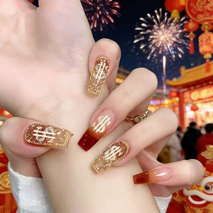Long coffin nails with gold glitter and red-brown gradient featuring dollar sign charms
