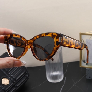 Close-up of vintage tortoiseshell cat-eye sunglasses with thick frames and dark lenses
