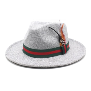 Detail of wool fedora hat with signature green-red stripe ribbon and feather accent