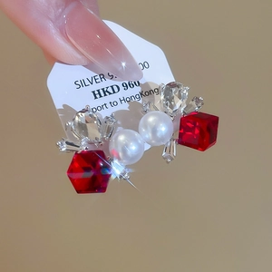 Close-up of square flower pearl earrings with red crystals and 925 silver studs