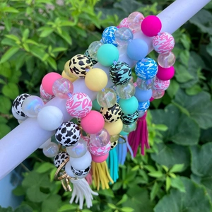 Close-up of colorful beaded wristlet keychains with leopard print beads and matching tassels