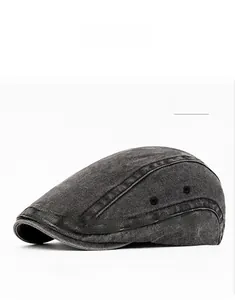 Detail of washed black canvas flat cap showing vintage texture and metal side eyelets
