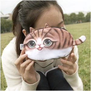 Close-up of realistic plush cat pouch with 3D tail and ears in a natural outdoor setting