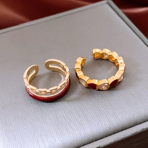 Detail of gold-plated double-layer chain ring with red enamel and heart-shaped zirconia