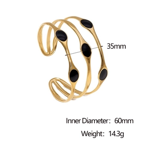 Detail view of 18k gold plated open cuff with black enamel and 35mm width specifications