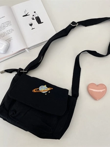 Minimalist black canvas crossbody bag with planet embroidery and adjustable strap