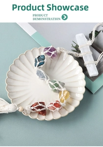 Dettaglio di sette pietre naturali chakra tessute a mano con nappe di cotone su ceramica