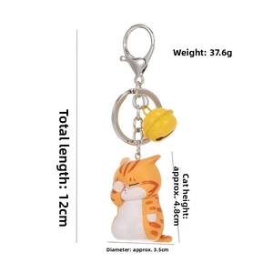 Detailed view of orange tabby cat keychain with bell and dimension markings
