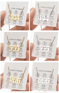 Detailed grid view of gold and silver angel number necklaces on informational cards