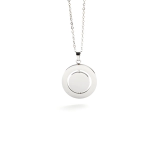 Macro detail of rotating silver stainless steel double circle pendant with smooth finish
