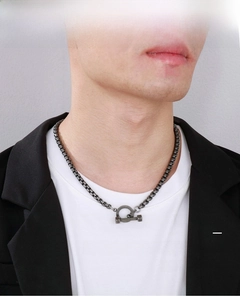 Close-up of industrial style titanium steel square chain with toggle clasp on model