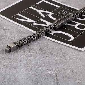 Detail of a vintage Byzantine steel bracelet with a secure fold-over clasp on a stone surface