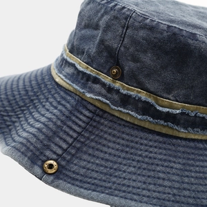 Detail of washed navy denim sun hat featuring olive webbing and copper rivets