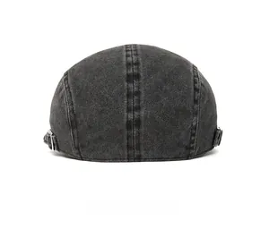 Rear view of washed cotton flat cap featuring adjustable metal side buckles and stitching